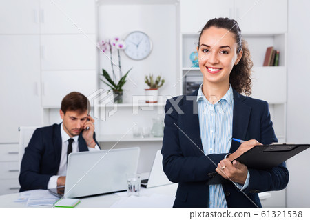 Glad business female secretary having cardboard in hands 61321538