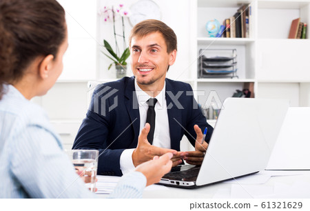 Man manager sitting and working on computer 61321629