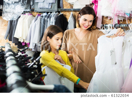 Family choosing dress in shop 61322034