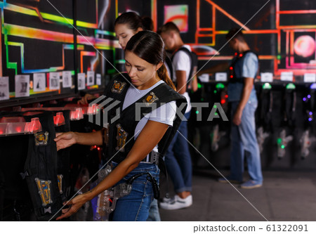 Positive friends looking laser guns and clothes Positive friends looking laser guns and clothes 61322091