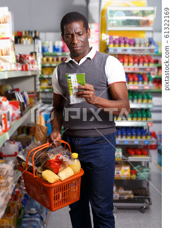 Man with cart shopping in store Man with cart shopping in store 61322169