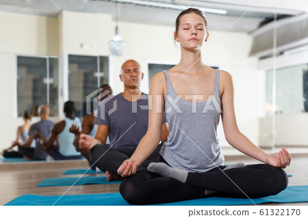 Adult girl making yoga meditation in lotus pose 61322170