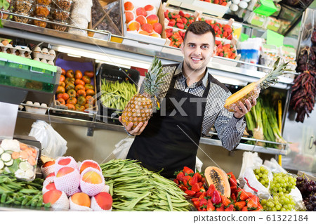 shopping assistant demonstrating assortment of grocery shop shopping assistant demonstrating assortment of grocery shop 61322184