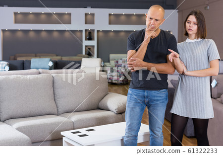 Couple choosing new sofa Couple choosing new sofa 61322233