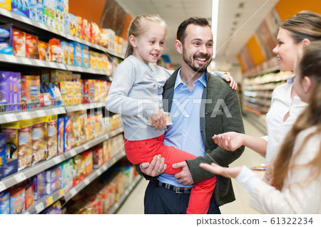 Happy family is talking about shopping in the supermarket. Happy family is talking about shopping in the supermarket. 61322234