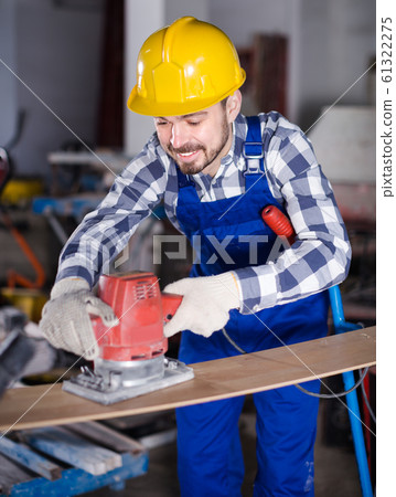 Adult is using grinder for construction work Adult is using grinder for construction work 61322275