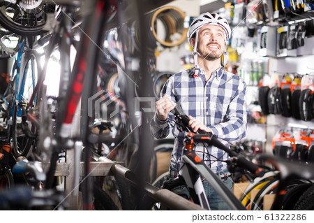 Casual biker cyclist is buying high-speed bike 61322286