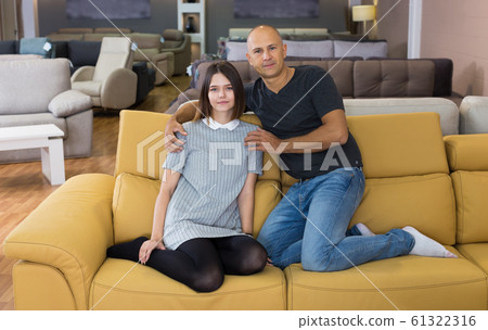 Couple sitting and testing new sofa Couple sitting and testing new sofa 61322316