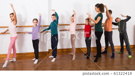 Group of children practicing at the ballet barre 61322419