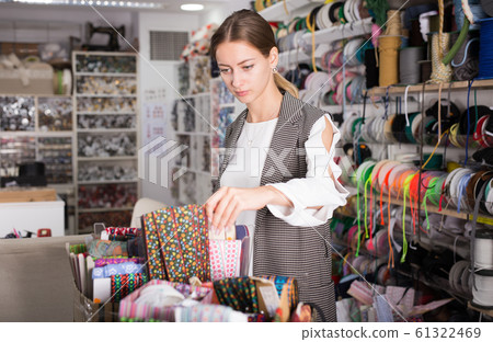 Woman choosing colorful ribbons Woman choosing colorful ribbons 61322469