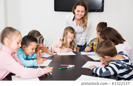 serious little children with teacher drawing in classroom serious little children with teacher drawing in classroom 61322537