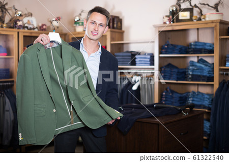 Customer examining suits Customer examining suits 61322540