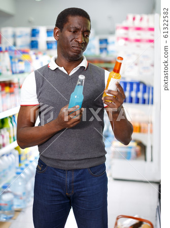 Adult man holding bottles of carbonated drinks Adult man holding bottles of carbonated drinks 61322582