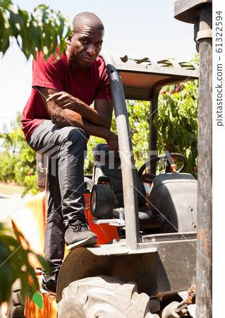 Afro male driver working on forklift 61322594