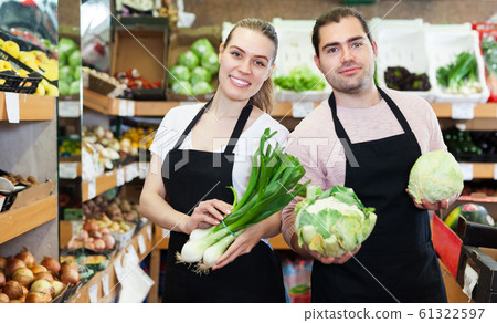 Two sellers offering vegetables 61322597