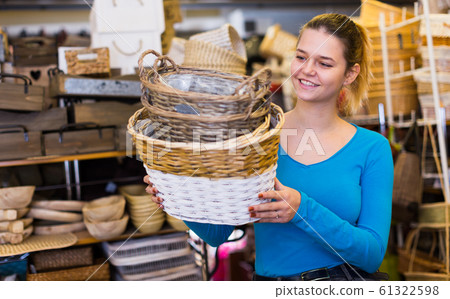 Female teen standing with wicker basket Female teen standing with wicker basket 61322598