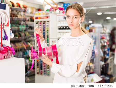 Salesgirl demonstrating ribbons Salesgirl demonstrating ribbons 61322650