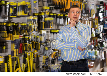 Portrait of male standing near showcase Portrait of male standing near showcase 61322676