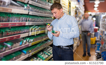 Man buying fasteners, screws, nails 61322790