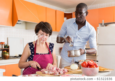 Woman cooking with African husband 61322836