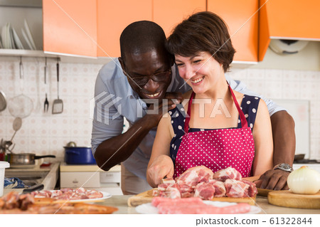 Couple making meat dinner Couple making meat dinner 61322844