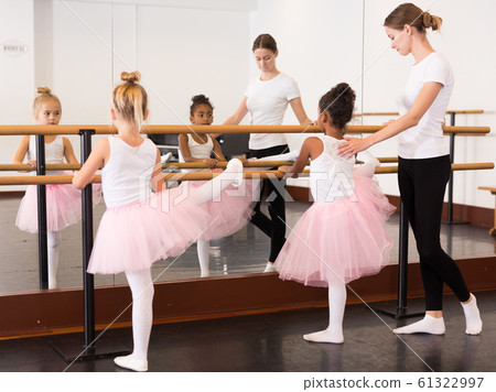 Ballet trainer teaching two little girls Ballet trainer teaching two little girls 61322997