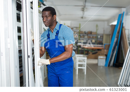 Adult man master is looking on modern window frame 61323001