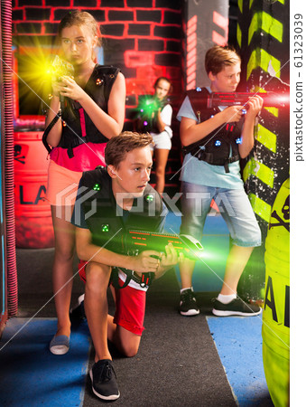 Teenagers having fun on lasertag arena Teenagers having fun on lasertag arena 61323039