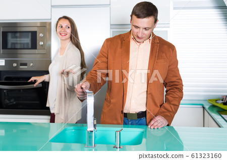 Positive couple customers choosing tabletop Positive couple customers choosing tabletop 61323160