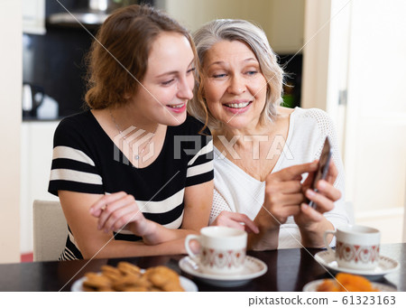 Mother with daughter using smartphone Mother with daughter using smartphone 61323163