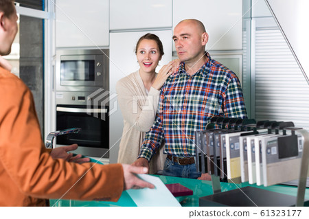 Dissatisfied couple customers at kitchen store Dissatisfied couple customers at kitchen store 61323177