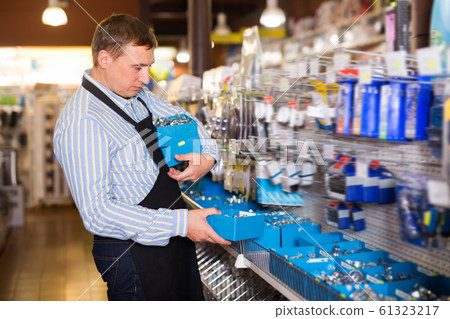 Portrait of male seller with goods 61323217