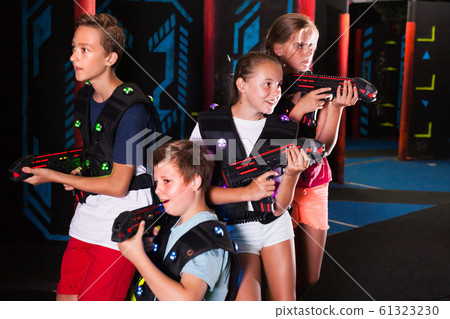 Girls and boys posing with laser pistols Girls and boys posing with laser pistols 61323230
