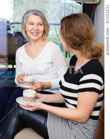 Two women talking at home Two women talking at home 61323231