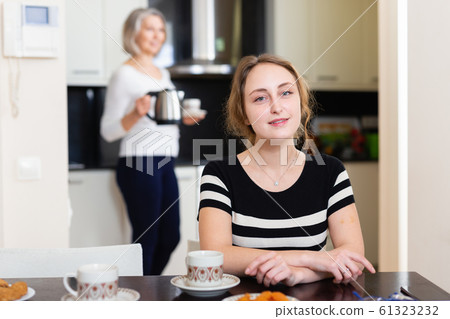 Woman at kitchen table Woman at kitchen table 61323232