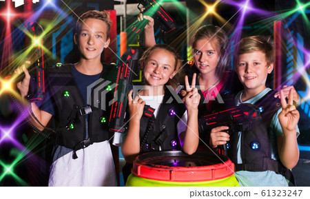 Girls and boys posing with laser pistols Girls and boys posing with laser pistols 61323247