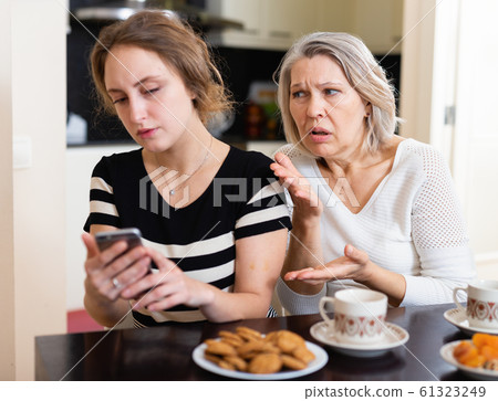 Upset women using smartphone 61323249