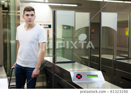 Man passing baffle gate in metro station Man passing baffle gate in metro station 61323298