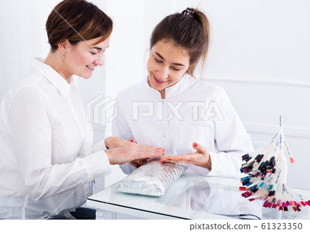 Woman doing manicure 61323350