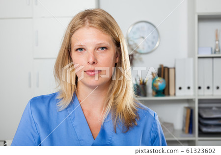 Woman medical worker standing in office Woman medical worker standing in office 61323602
