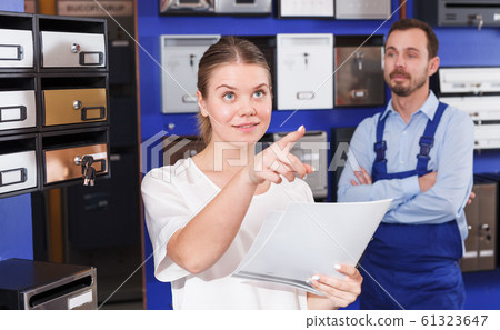 Girl consulting about mailbox with worker 61323647