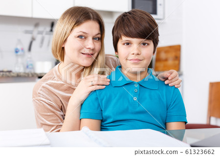 Family doing homework at kitchen Family doing homework at kitchen 61323662