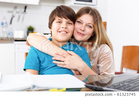 Family doing homework at kitchen 61323745