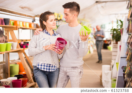 Couple choosing flowerpots 61323788
