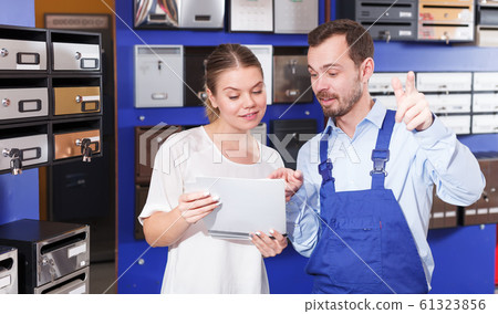 woman with salesman choosing postbox salesman 61323856