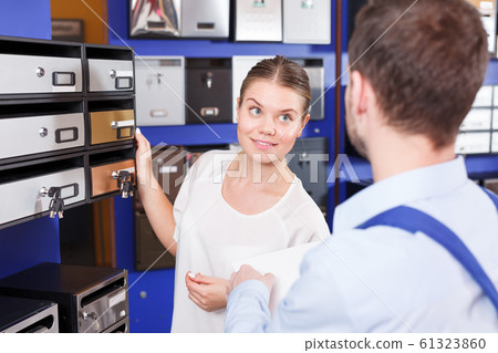 woman with guy seller selecting postbox woman with guy seller selecting postbox 61323860