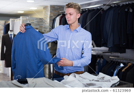 male in suit choosing jacket male in suit choosing jacket 61323969
