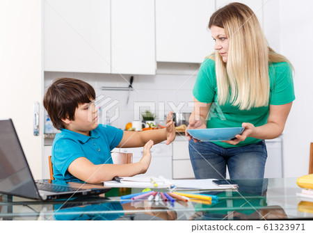 Displeased boy refusing to eat Displeased boy refusing to eat 61323971
