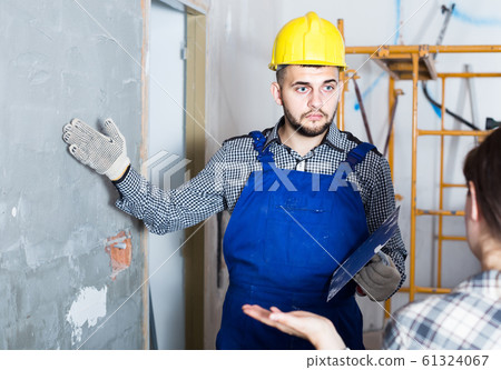 Worker man is clarifying details of work from client. Worker man is clarifying details of work from client. 61324067