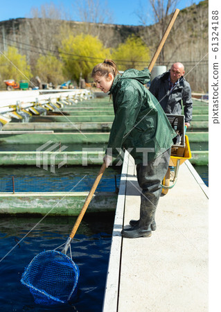 Male and female catching fish from reservoir 61324188